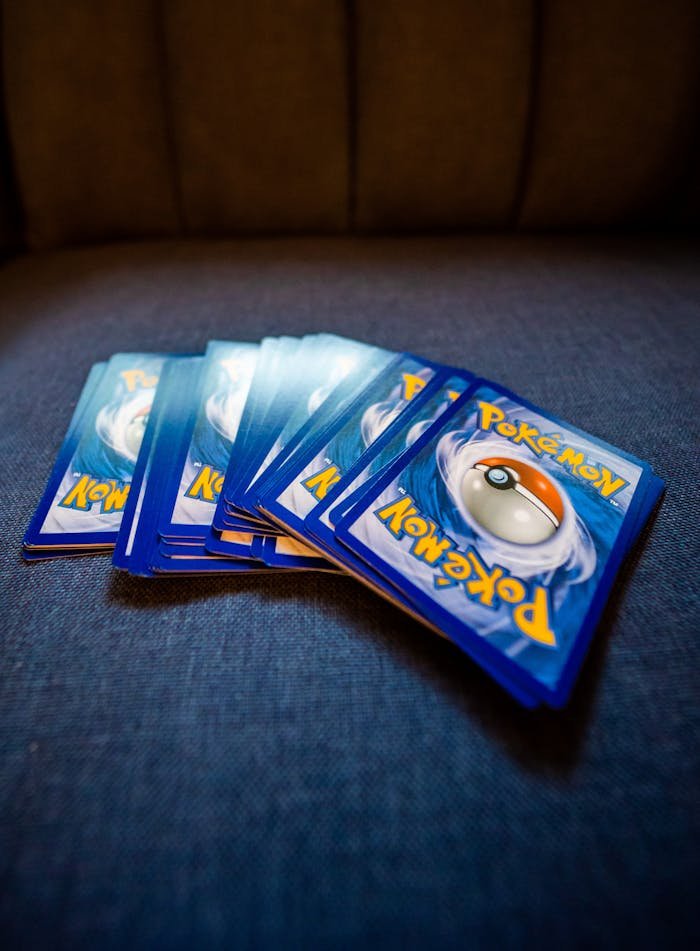 The Art of Drawing Readers In: Your attractive post title goes here A collection of Pokemon trading cards arranged on a blue couch, ideal for collectors and fans.